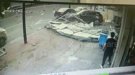 Roof narrowly misses passersby after winds rip it off house in China