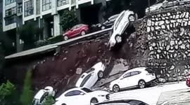 Road collapses just seconds after woman and child pass by in southern China