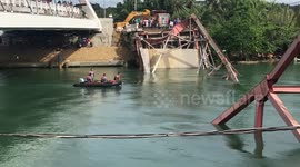 Rescue teams search wreckage of collapsed bridge in the Philippines