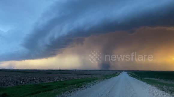 Powerful tornado forms at sunset over Kansas plains