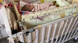 Chinese father builds device to rock his child's bed so his wife doesn't have to