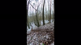 Bike rider girl jumps very far and fast down the hill with her bike