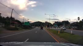 Sack of palm fruit falls from back of moving truck