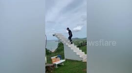 Tourists breaks wooden stairs while posing for a picture