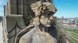 A tree finds a way to grow on the shoulder of one of the enormous Guardians of Traffic statues in Cleveland, Ohio
