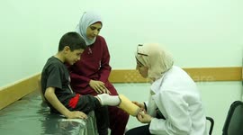 Palestinian child Saleh Hamid, 7, whose foot was amputated following an Israeli airstrike last year, checks his prosthesis