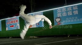 Pandemic worker in China performs impressive flips while wearing protective clothing