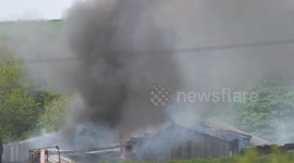 A major farm fire spreads through buildings before fire services arrive at Quoit Farm near St Columb Major Cornwall UK.