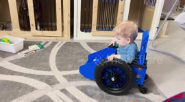 US toddler with spina bifida has mastered the use of his tiny wheelchair and can finally play with toys