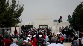Palestinian wave national flags as they march in a rally marking the 74th anniversary of the 