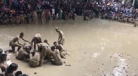 Wrestling festival in the mud fighting for wooden balls held in Vietnam