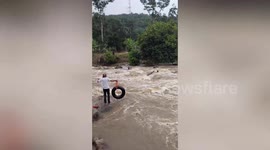 Villagers rescue man trapped in raging river in Malaysia