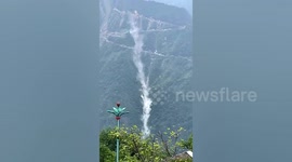 Landslide tumbling down Chinese mountain resembles cascading waterfall