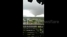 Footage of tornado spinning in the distance in southern China
