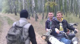 Three guys use birch tree branch as selfie stick
