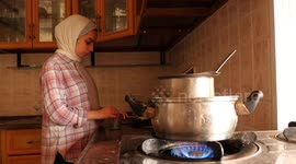Palestinian girl, Ghada Abu Samra, 22, makes candles at her home in Gaza City.