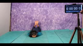 A girl in South India performs splits by balancing her body with the chin