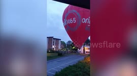 Dramatic footage shows hot air balloon landing in car park after nearly hitting houses