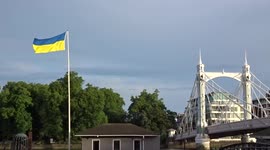 Ukraine flag flying on Cadogan Pier on the River Thames next to the Albert Bridge - London
