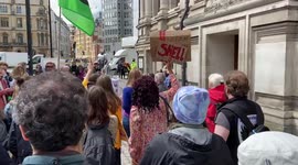 Protesters chant “Shame on Shell” outside Shell’s annual general meeting