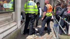 A protester lies on the ground during Shell’s annual general meeting