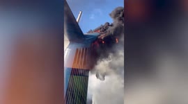 Dark smoke billows from smokestack as cruise ship burns in Grand Turk dock