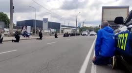 Ukrainians in Vinnytsia kneel as funeral convoy passes, to pay respects to killed soldiers