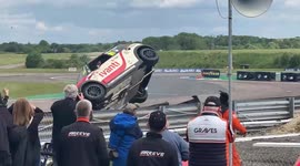 Mini car rolls after colliding with another race car which shocks the spectators watching.