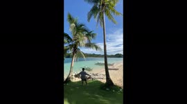 Hammock snaps while a man swings on it for a photo in Philippines' Siargao Island