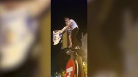 FALL FROM GRACE - Real Madrid fans danced on the top of a set of traffic lights - which smashed to the ground following the Champion's League Final