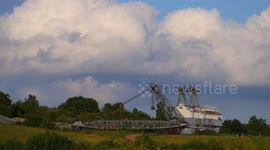 Timelapse of Cumulus clouds behind a giant historic coal mining machine in West Yorkshire