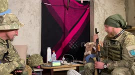 Ukrainian soldiers cheer for their side during World Cup qualifier