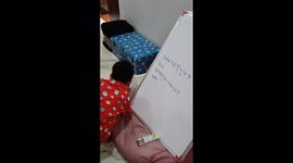 Little cute kids write on board in Gujarati language and enjoy the moment with learning in childhood.  My son, studying at home.