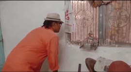 Watch - Baby Snake in a bid to hunt a rat stuck into rat trap cage , later rescued by a snake rescuer