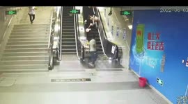 Cleaner springs into action despite falling over after couple tumble down escalator