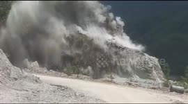 Dramatic industrial explosion footage of mountain blast during road construction on mountains