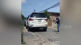 Driver jumps into car boot to avoid monitor lizard lurking under his vehicle