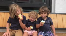 Three brothers eat ice cream
