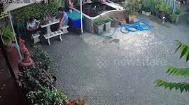 Resident sitting at garden table gets a fright when snake creeps up on him