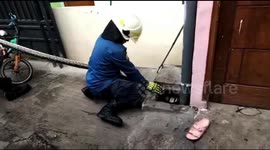 Heave! Jakarta firefighters pull on 3-metre python like tug-of-war to evacuate it from a drain