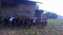 More than fifty villagers lift entire wooden house to help neighbour move