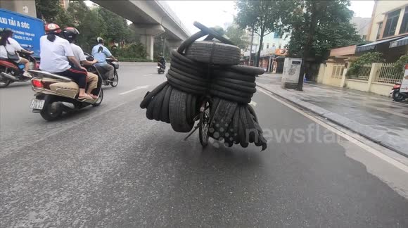Motorbikes overloaded with goods are a common sight on Vietnamese roads
