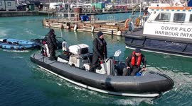 Dinghies being towed into Dover port by Border Force RHIB