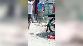 Builder with one leg inspires onlookers as he mixes heavy cement on construction site