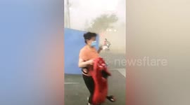 Steel hoarding blown away by powerful winds knocks woman over in China