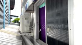 DIY gone wrong! Homeowner, 45, rescued after getting stuck in tiny gap between two homes