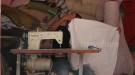 Palestinian man, Salim Al-Aklouk, 58, makes a cotton-stuffed pillows, blankets, sheets and cushions at his shop in Gaza city