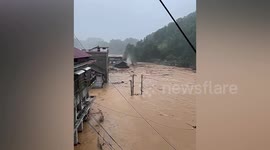 Residents watch on helplessly as houses swallowed in rapid floodwater in southern China