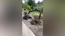 Dig it! Toddler expertly operates mini excavator built by father