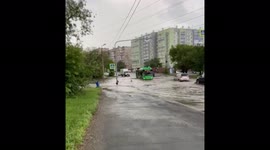 Children bathed in a puddle near the roadway in Chelyabinsk